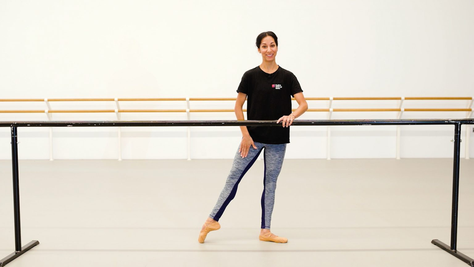 A teacher of dance classes for adults stands in a dance studio