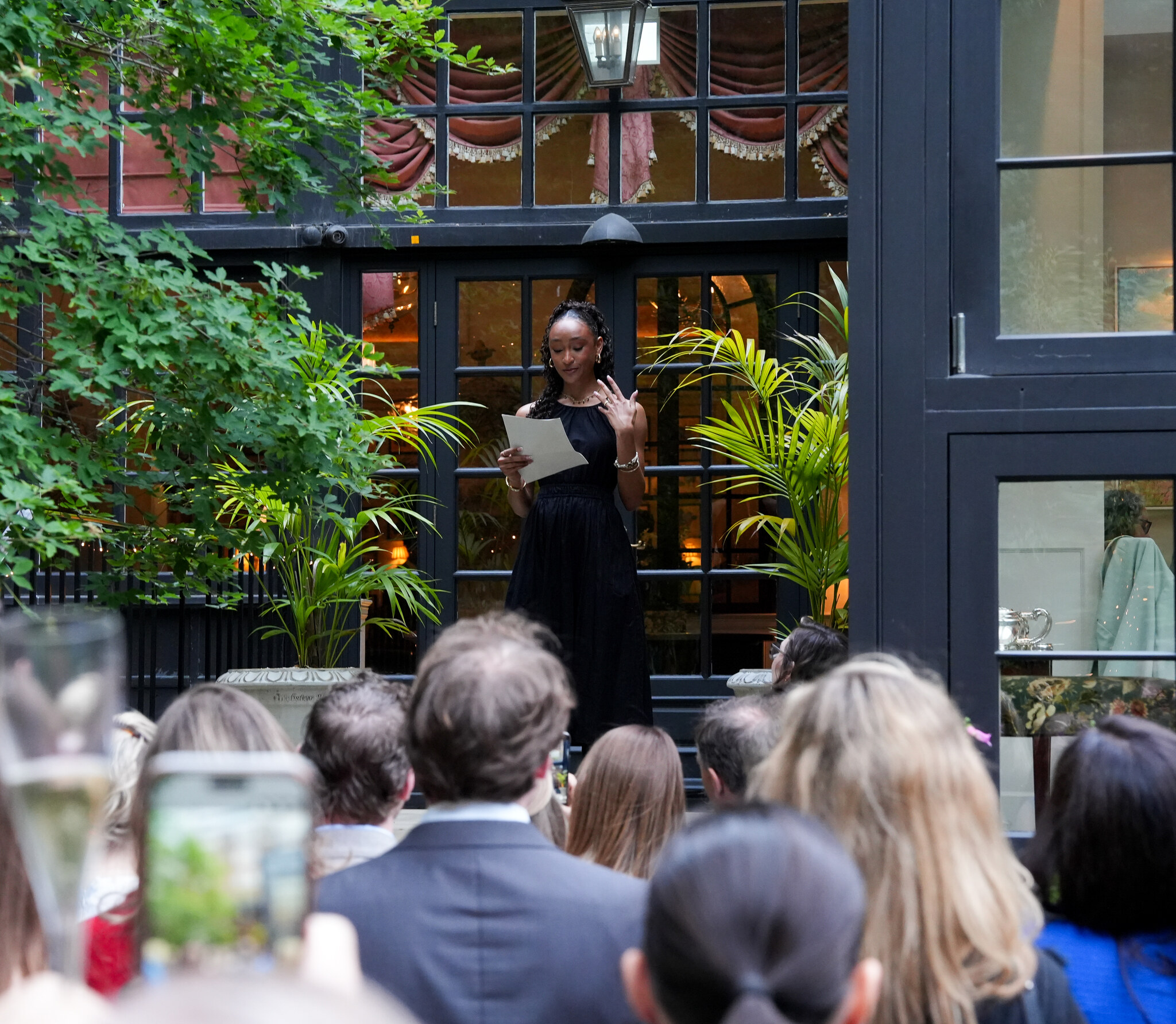 Taela Graff speaking at an Event in front of an audience.